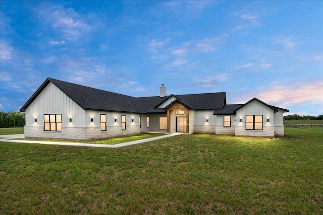 1754 County Road 146th Rd, Georgetown, TX 78633 - modern inspired farmhouse featuring board and batten siding, a chimney, stone siding, and a yard