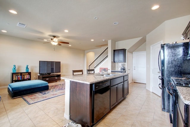 kitchen featuring black appliances, a sink, a ceiling fan, light stone countertops, and recessed lighting