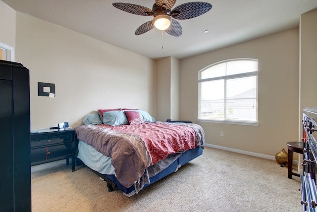 bedroom with carpet flooring, baseboards, and a ceiling fan