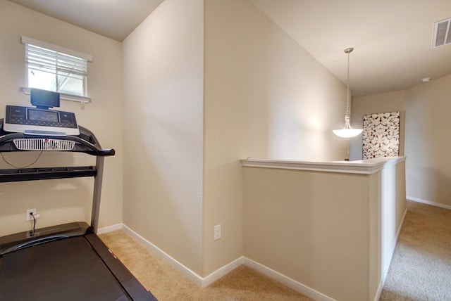 workout room featuring carpet flooring and baseboards