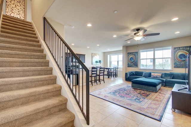 living room featuring ceiling fan, stairs, recessed lighting, and light tile patterned floors