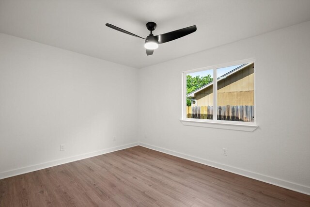 1417 Charolais Dr, Austin, TX 78758 - spare room with wood finished floors, baseboards, and a ceiling fan