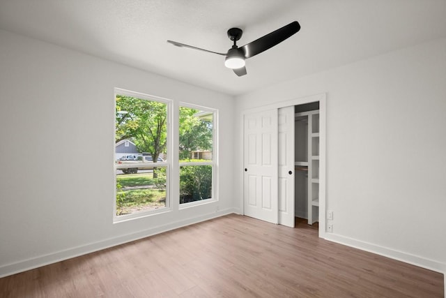 1417 Charolais Dr, Austin, TX 78758 - unfurnished bedroom with baseboards, wood finished floors, ceiling fan, and a closet
