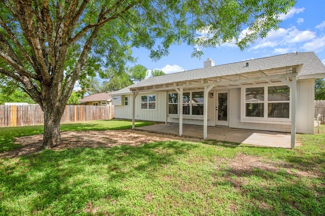 1417 Charolais Dr, Austin, TX 78758 - back of property featuring a patio area, a chimney, and board and batten siding