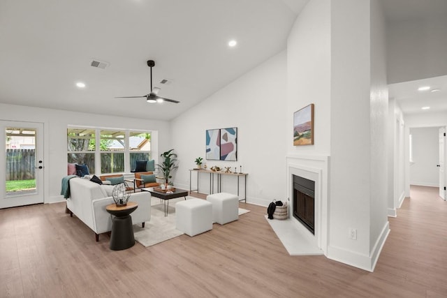 1417 Charolais Dr, Austin, TX 78758 - living area featuring high vaulted ceiling, wood finished floors, recessed lighting, a fireplace with flush hearth, and baseboards