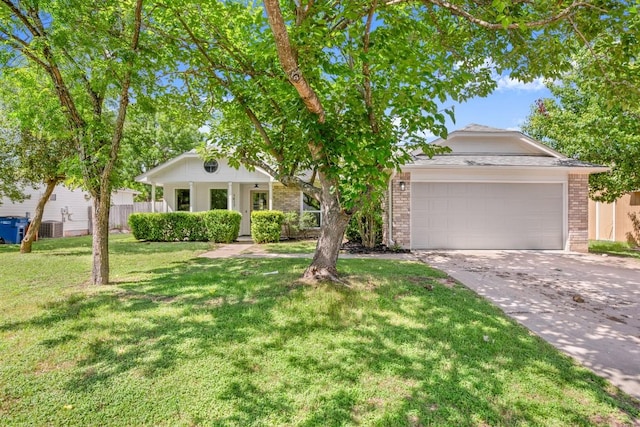 1417 Charolais Dr, Austin, TX 78758 - view of front of home with driveway, brick siding, an attached garage, and a front lawn