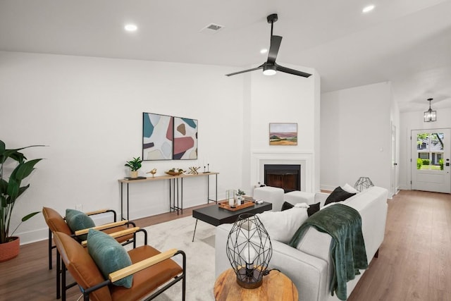 1417 Charolais Dr, Austin, TX 78758 - living room with wood finished floors, recessed lighting, a ceiling fan, baseboards, and a fireplace