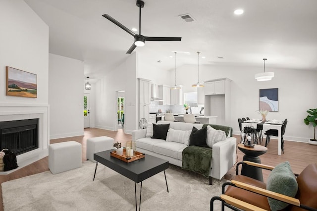 1417 Charolais Dr, Austin, TX 78758 - living room with ceiling fan, light wood-type flooring, a fireplace with flush hearth, recessed lighting, and high vaulted ceiling