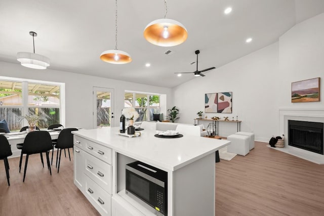 1417 Charolais Dr, Austin, TX 78758 - kitchen with open floor plan, lofted ceiling, light wood-style floors, pendant lighting, and recessed lighting