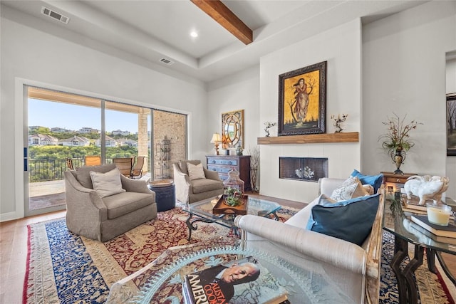 2032 Murano Ln, Leander, TX 78641 - living area featuring beamed ceiling, a fireplace, wood finished floors, recessed lighting, and a high ceiling