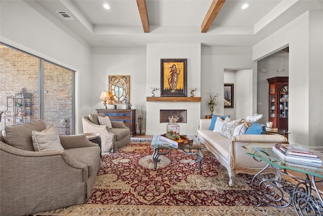 living area featuring beamed ceiling and recessed lighting
