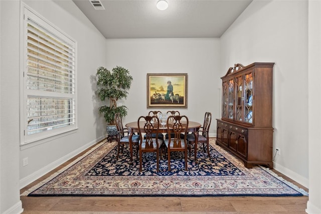 dining area featuring wood finished floors and baseboards