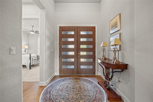 2032 Murano Ln, Leander, TX 78641 - entrance foyer featuring wood-type flooring, french doors, a ceiling fan, and baseboards