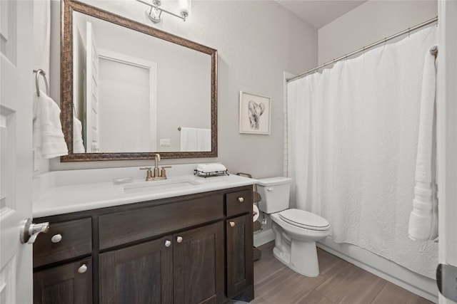 full bath with toilet, wood finished floors, vanity, and a shower with curtain