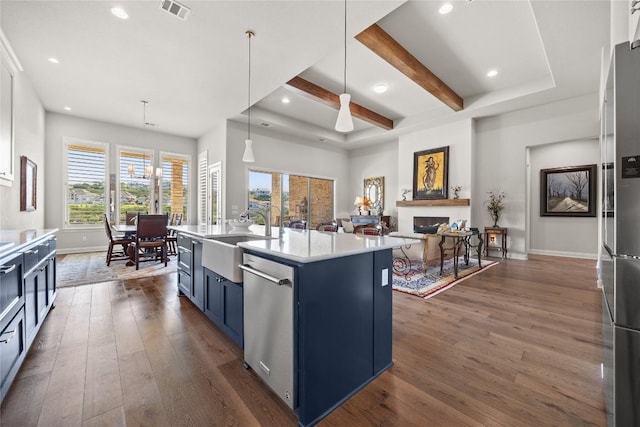 2032 Murano Ln, Leander, TX 78641 - kitchen featuring a sink, blue cabinetry, appliances with stainless steel finishes, dark wood-style floors, and light countertops