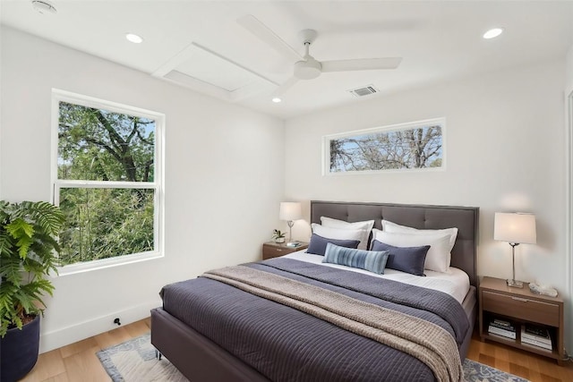 bedroom featuring attic access, wood finished floors, recessed lighting, a ceiling fan, and baseboards