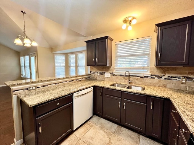 kitchen with a sink, dishwasher, a peninsula, healthy amount of natural light, and lofted ceiling
