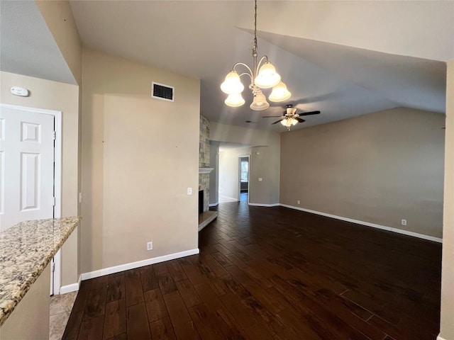 unfurnished dining area featuring ceiling fan, hardwood / wood-style flooring, baseboards, a chandelier, and lofted ceiling