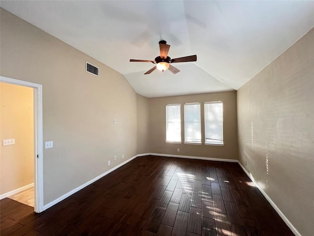 empty room featuring a ceiling fan, hardwood / wood-style floors, vaulted ceiling, and baseboards