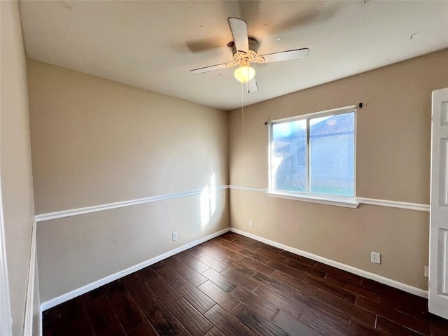 empty room featuring wood finished floors, baseboards, and ceiling fan
