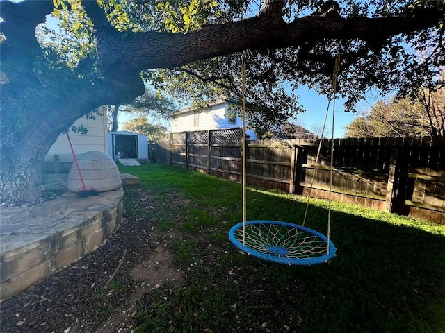 view of yard featuring a storage unit and an outbuilding