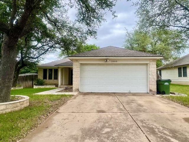1800 Columbine Ln, Leander, TX 78641 - ranch-style house featuring driveway, a garage, stone siding, a front lawn, and roof with shingles