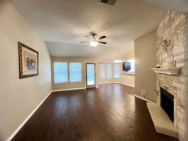 1800 Columbine Ln, Leander, TX 78641 - unfurnished living room with ceiling fan, baseboards, plenty of natural light, vaulted ceiling, and dark wood-style floors