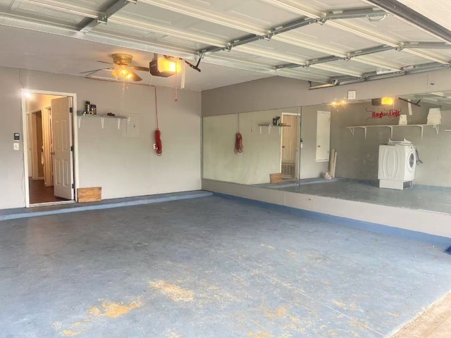 garage with washer / clothes dryer and a garage door opener