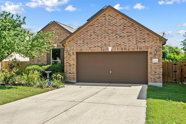 6212 Bumpstead Dr, Austin, TX 78747 - view of front facade with brick siding, driveway, and an attached garage