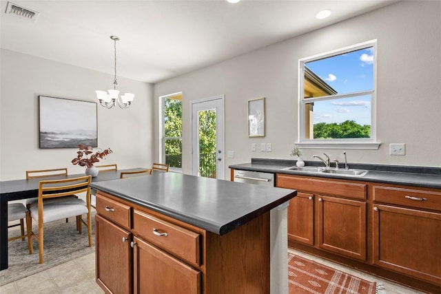 6212 Bumpstead Dr, Austin, TX 78747 - kitchen with a sink, dark countertops, a chandelier, and a center island