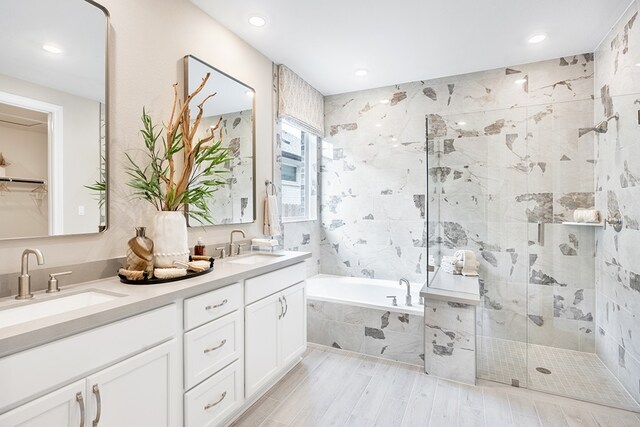 209 Golden Sage Ave, Georgetown, TX 78633 - full bath with a garden tub, double vanity, a stall shower, recessed lighting, and wood finished floors
