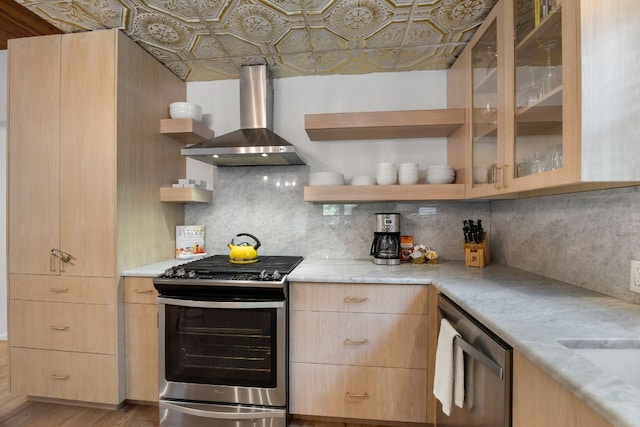 1307 E 2nd St, Austin, TX 78702 - kitchen featuring stainless steel appliances, wall chimney range hood, light brown cabinetry, open shelves, and an ornate ceiling