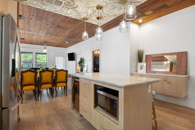 1307 E 2nd St, Austin, TX 78702 - kitchen featuring appliances with stainless steel finishes, light wood-type flooring, a kitchen island, modern cabinets, and wooden ceiling