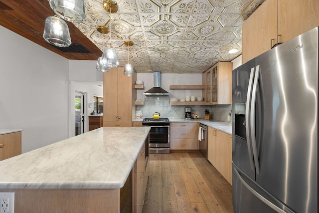 1307 E 2nd St, Austin, TX 78702 - kitchen with stainless steel appliances, wall chimney range hood, an ornate ceiling, open shelves, and decorative backsplash