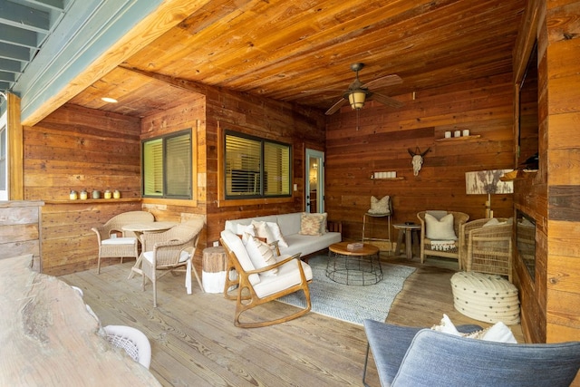 1307 E 2nd St, Austin, TX 78702 - living area featuring wood finished floors, a ceiling fan, and wood walls