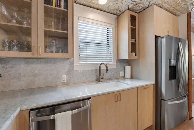 1307 E 2nd St, Austin, TX 78702 - kitchen with stainless steel appliances, a sink, light brown cabinetry, backsplash, and an ornate ceiling