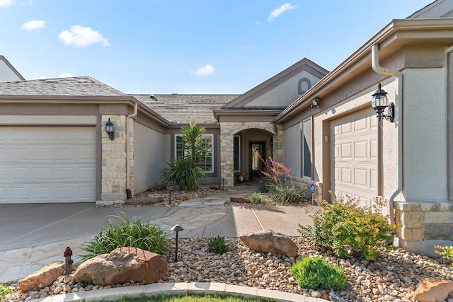 307 Palmetto Dr, Georgetown, TX 78633 - doorway to property with a garage, stone siding, stucco siding, concrete driveway, and a shingled roof