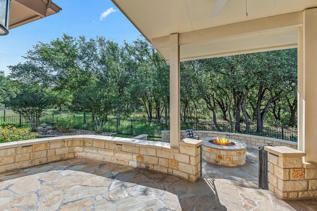 307 Palmetto Dr, Georgetown, TX 78633 - view of patio featuring an outdoor fire pit, a fenced backyard, a ceiling fan, and view of scattered trees