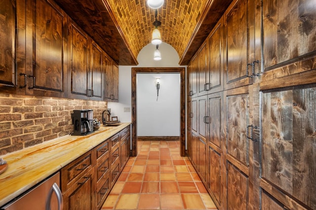 164 Camino Del Reserve, Comfort, TX 78013 - kitchen with brick ceiling, a sink, lofted ceiling, tasteful backsplash, and baseboards