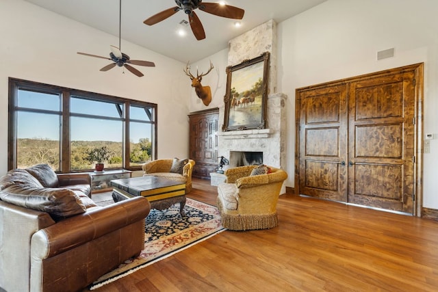 164 Camino Del Reserve, Comfort, TX 78013 - living room featuring high vaulted ceiling, ceiling fan, wood finished floors, and a large fireplace