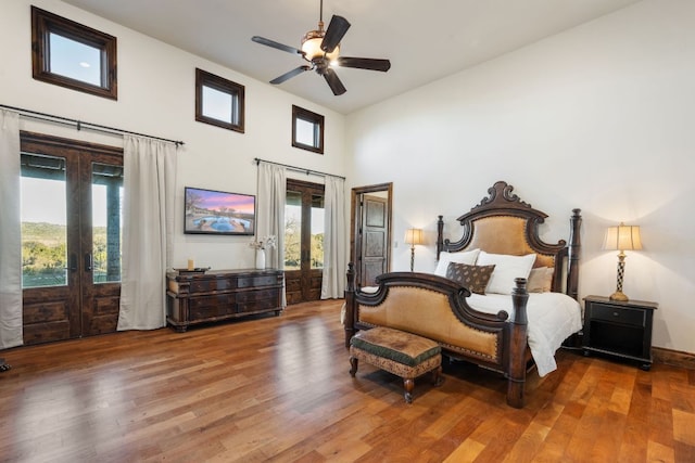 164 Camino Del Reserve, Comfort, TX 78013 - bedroom with french doors, access to exterior, a towering ceiling, wood finished floors, and a ceiling fan
