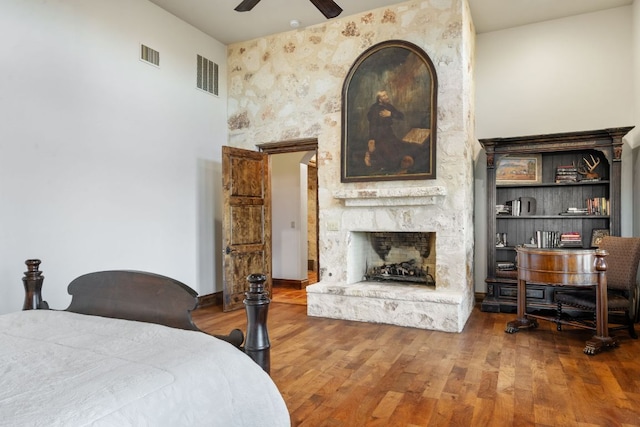 164 Camino Del Reserve, Comfort, TX 78013 - bedroom with a fireplace and wood finished floors
