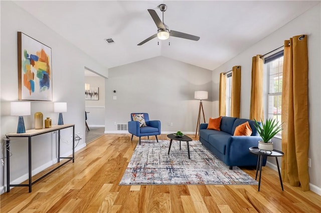 sitting room with ceiling fan, vaulted ceiling, wood finished floors, and baseboards