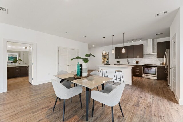 6444 Burnet Rd Unit 204, Austin, TX 78757 - dining space with light wood finished floors and track lighting