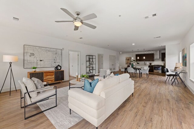 6444 Burnet Rd Unit 204, Austin, TX 78757 - living area featuring light wood finished floors and ceiling fan