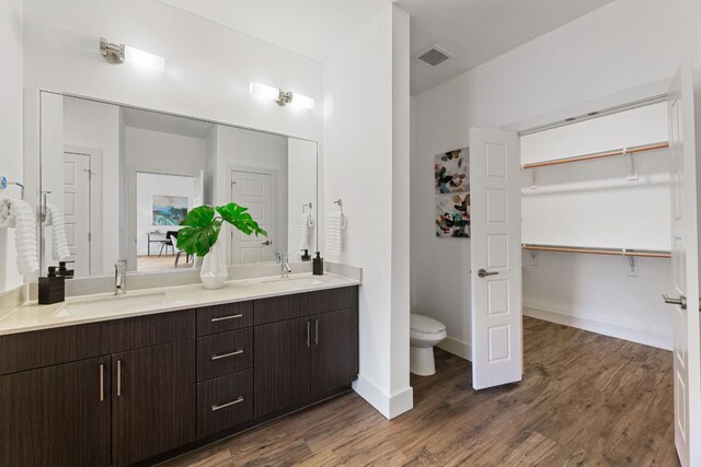 6444 Burnet Rd Unit 204, Austin, TX 78757 - full bath featuring double vanity and wood finished floors