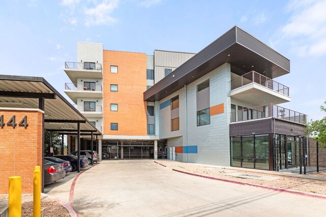 6444 Burnet Rd Unit 204, Austin, TX 78757 - view of property featuring covered parking