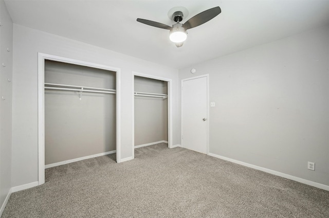 4905 Southcrest Dr, Austin, TX 78746 - unfurnished bedroom featuring carpet, two closets, a ceiling fan, and baseboards