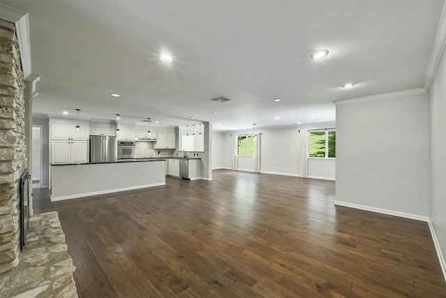 4905 Southcrest Dr, Austin, TX 78746 - unfurnished living room with recessed lighting, dark wood-style flooring, baseboards, ornamental molding, and a stone fireplace