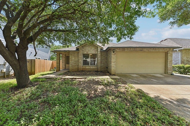 1208 Water Spaniel Way, Round Rock, TX 78664 - view of front of home featuring a garage, concrete driveway, fence, and brick siding